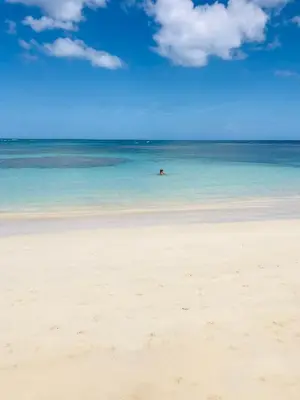 a person swimming in the ocean on a beach at Piece of Paradise in Las Terrenas