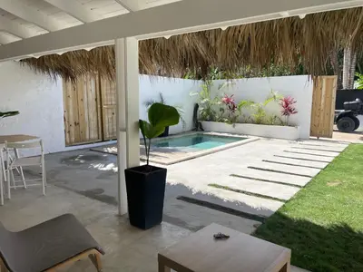 a patio with a pool and a table and a plant at Villa Tortuga, Guest house Private bungalow, private pool in Las Terrenas