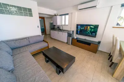 a living room with a couch and a table at Kite Beach Oceanfront 1st Row Two Bedrooms and patio in Cabarete