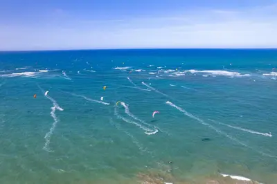 a group of people kite surfing in the ocean at Studio Beachfront Kite Beach in Cabarete
