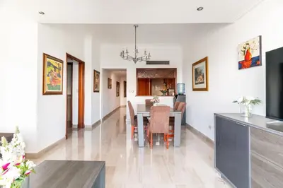 a dining room and kitchen with a table and chairs at Luxurious 2BDR condo located in Prestigious Tower. in Santo Domingo