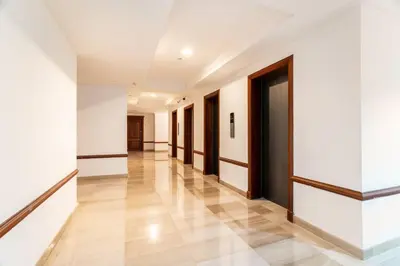an empty hallway with white walls and wooden doors at Luxurious 2BDR condo located in Prestigious Tower. in Santo Domingo