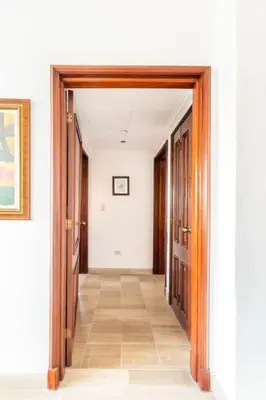 a hallway with two doors and a tile floor at Luxurious 2BDR condo located in Prestigious Tower. in Santo Domingo