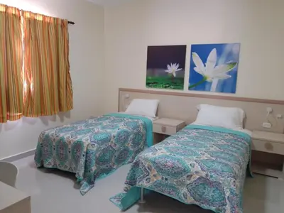 a hospital room with two beds and a window at CoralK Apartments Sosúa in Sosúa