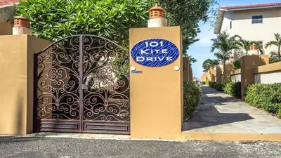 a gate with a sign on it in front of a house at Ocean Dream 1st See Line Studio in Cabarete