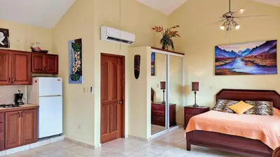 a bedroom with a bed and a refrigerator at Ocean Dream 1st See Line Studio in Cabarete