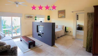 a living room with a bed and stars on the wall at Ocean Dream High Ceiling Studio w/balcony in Cabarete
