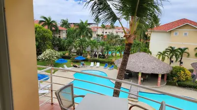 a view of the pool from the balcony of a resort at Ocean Dream Art Deco Studio w/balcony in Cabarete