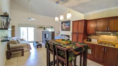 a kitchen with a table in the middle of a room at Ocean Dream Art Deco Studio w/balcony in Cabarete