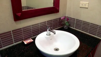 a bathroom with a white sink and a mirror at Ocean Dream 2bdr/2bth Ground floor in Cabarete
