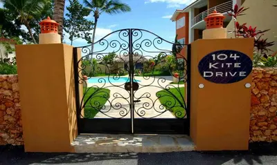 a gate to a house with a sign on it at Ocean Dream 2bdr/2bth Ground floor in Cabarete