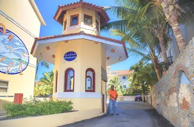 a man standing in front of a small building at Ocean Dream 3d floor studio w/balcony in Cabarete