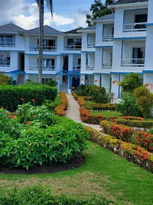 a building with a garden in front of it at Costarena Beach Hotel in Las Terrenas