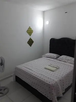 a bedroom with a bed with a black headboard at Wilkan Hotel in Las Terrenas