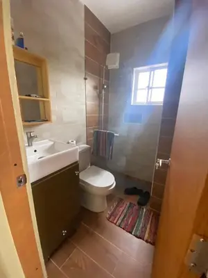 a bathroom with a white toilet and a sink at RESIDENCIAL DOÑA GLORIA in San Felipe de Puerto Plata