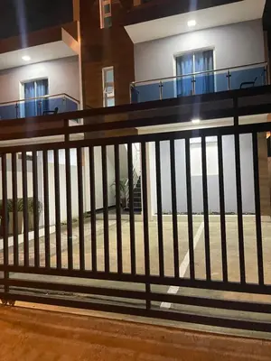 a fence in front of a building with windows at Residencial christall ap 2-A in Santiago de los Caballeros
