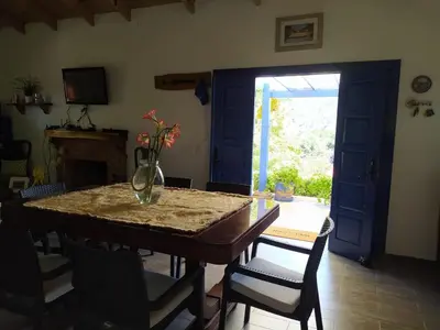 a dining room with a table with a vase on it at Chalet los Pinos Constanza in Arroyo Frío