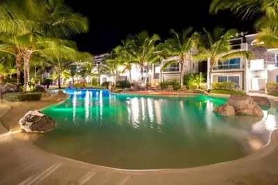 a pool at a resort at night at Sunny garden in La Laguna