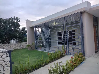 a house with a metal gate on the side of it at Cabrera Family Villa in Cabrera