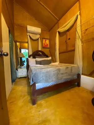 a bedroom with a bed in a room at Villas Don Che, 2 villas in Jarabacoa