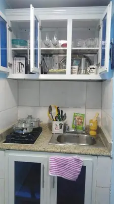 a kitchen counter with a sink and a stove at Paulino in Santiago de los Caballeros