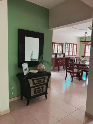 a living room with a table and a dining room at Villa paloma in Constanza