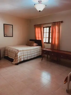 a bedroom with a bed and a window at Villa paloma in Constanza