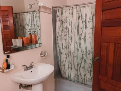 a bathroom with a sink and a shower curtain at Villa paloma in Constanza