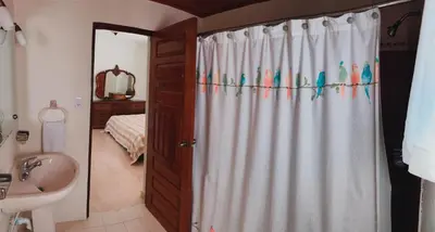 a bathroom with a shower curtain with birds on it at Villa paloma in Constanza