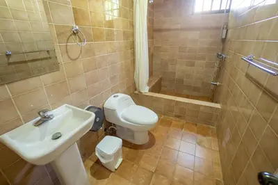 a bathroom with a toilet and a sink and a shower at Room #28 at Waterfront Playa Alicia in Sosúa