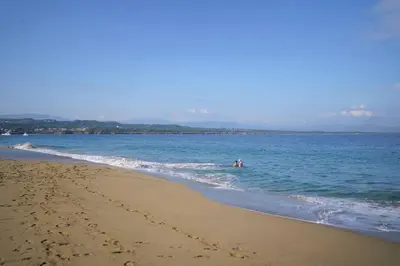 two people are in the water at the beach at Room #26 at Waterfront Playa Alicia in Sosúa