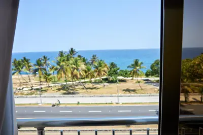 a view of a beach from a train window at LA VlTA E' BELLA in Los Mameyes