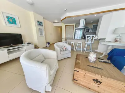 a living room with white furniture and a tv at 707 Marbella 2bedroom Beachfrom Apt in San Pedro de Macorís