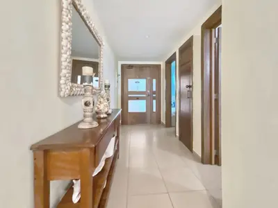 a hallway with a table and a mirror at 707 Marbella 2bedroom Beachfrom Apt in San Pedro de Macorís