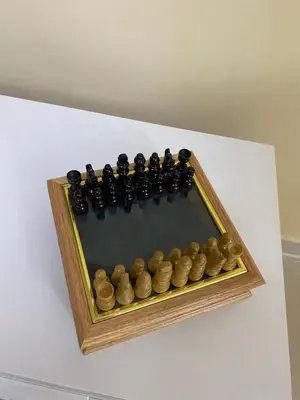 a wooden chess set in a wooden frame on a table at Casa Apartamento Valentina in Santo Domingo
