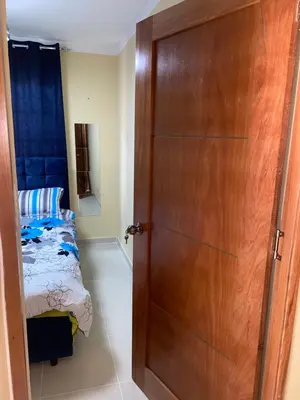 a door leading to a bedroom with a bed at Casa Apartamento Valentina in Santo Domingo