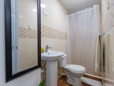 a bathroom with a toilet and a sink and a shower at Nice 1br-1bt With Common Picuzzi in Sosúa