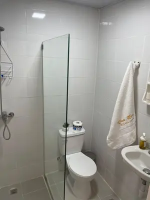 a white bathroom with a toilet and a sink at Central 1bd and Bth with common Picuzzi in Sosúa