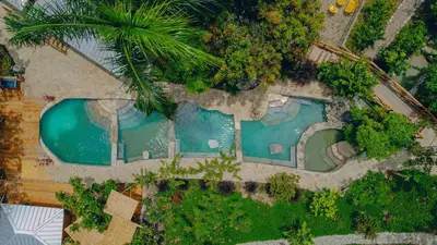 an overhead view of a swimming pool in a resort at EL GALLO ECOLODGE in San Felipe de Puerto Plata