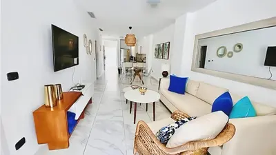 a living room with a couch and a table at Cana Rock Star, Vista al campo de golf y Piscina C-303, B-400, B-506 y B-502 - Desayuno in Punta Cana