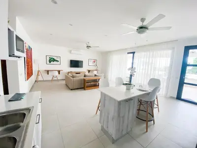 a living room with a table and a couch at Stella Aparthotel, Las Terrenas in Las Terrenas