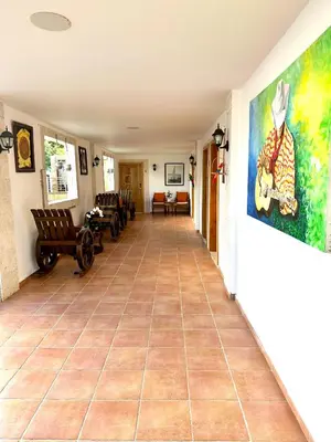 a hallway with a tile floor and a painting on the wall at Noe Hotel ,1 Bed Room 2 Near to the beach in Punta Cana