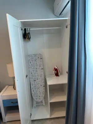 a white closet with a chair sitting in it at Noe Hotel ,1 Bed Room 2 Near to the beach in Punta Cana
