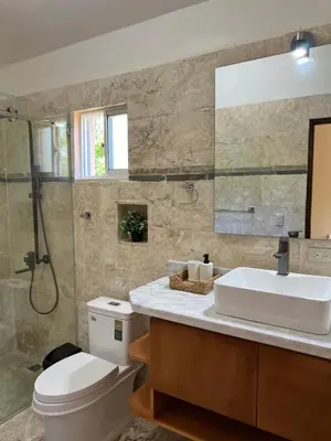 a bathroom with a toilet and a sink and a shower at Villa 102A, 5 master bedroom and 5 full bathrooms with private pool in Sosúa