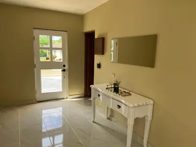 a room with a white table and a door at Villa 102A, 5 master bedroom and 5 full bathrooms with private pool in Sosúa