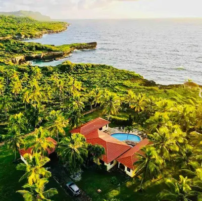 an aerial view of a house with palm trees and the ocean at PALM HOUSE - LUXURY VILLA - SAMANÁ - Ocean Front in Sánchez