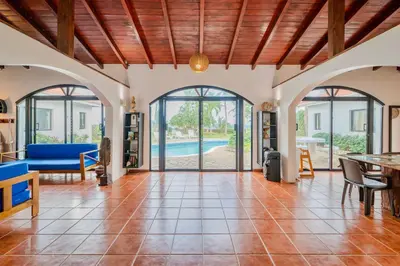 an open living room with doors to a pool at PALM HOUSE - LUXURY VILLA - SAMANÁ - Ocean Front in Sánchez