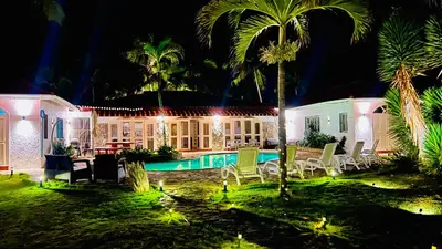 a house with a swimming pool at night at PALM HOUSE - LUXURY VILLA - SAMANÁ - Ocean Front in Sánchez