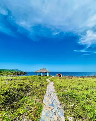 a path leading to a gazebo on a field with the ocean at PALM HOUSE - LUXURY VILLA - SAMANÁ - Ocean Front in Sánchez