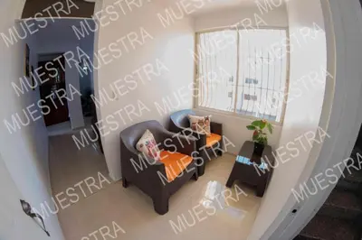 an overhead view of a living room with a couch and chairs at Apartamento en la carreras próximo al monumento in Santiago de los Caballeros